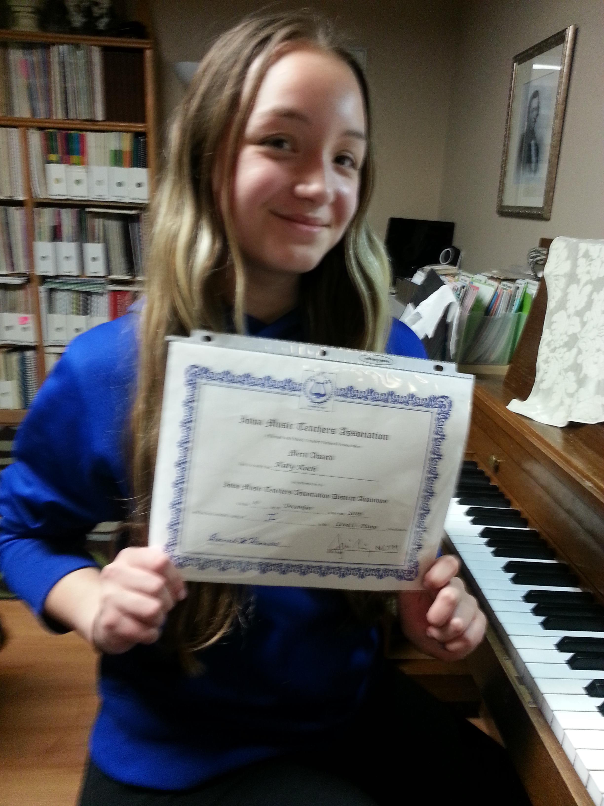 Piano Student showing pride with superior certificate from festival